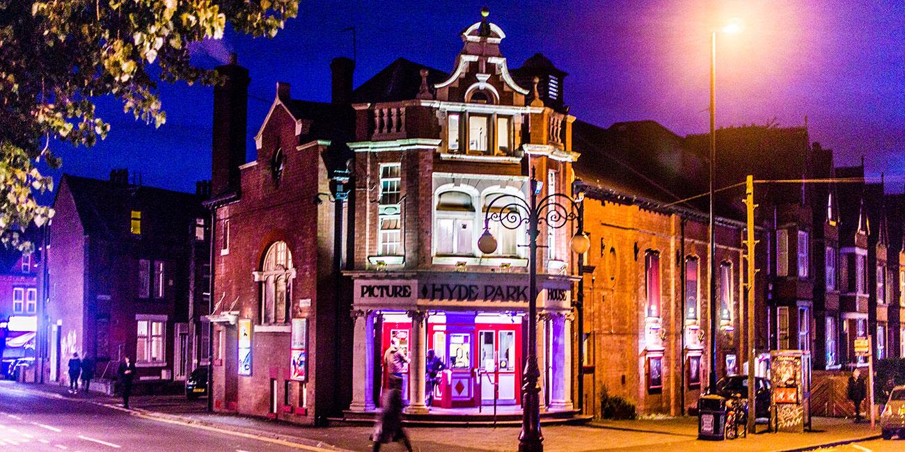 The front of Hyde Park Picture House cinema at night.