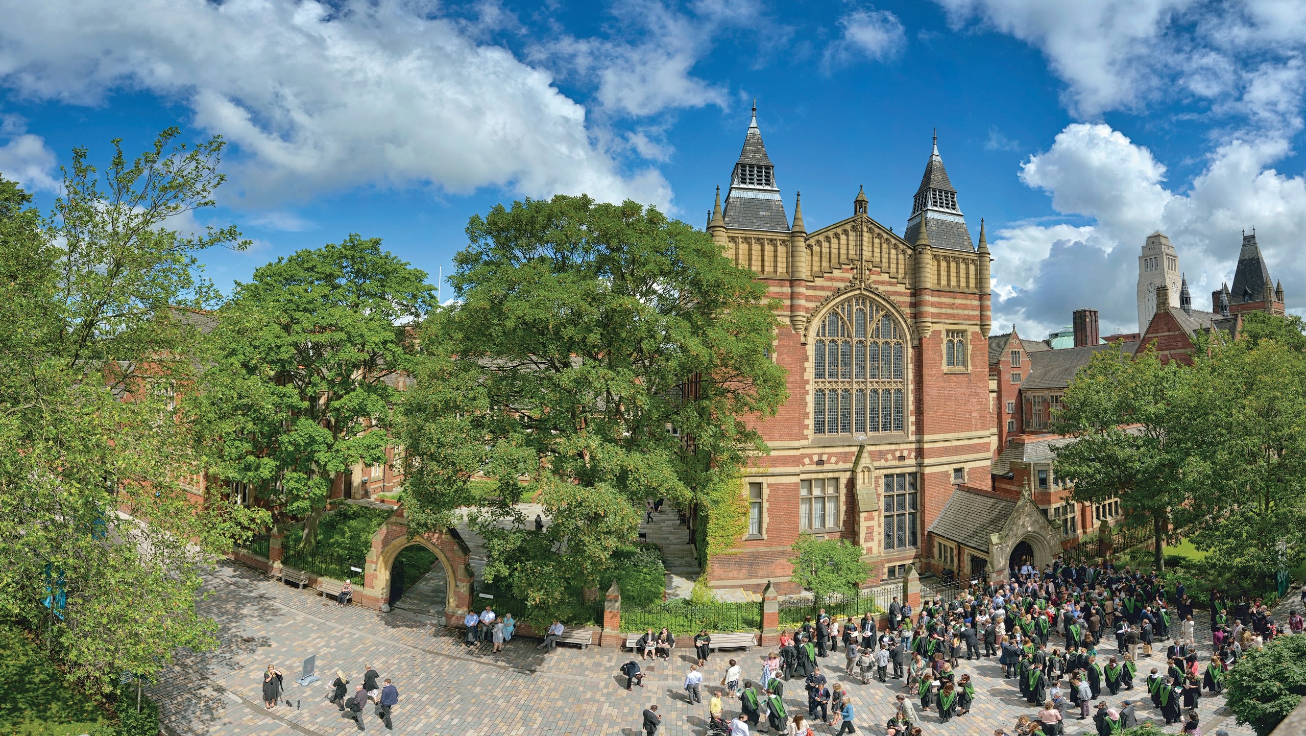 Aerial shot of graduating students outside Great Hall in summer time with a blue sky