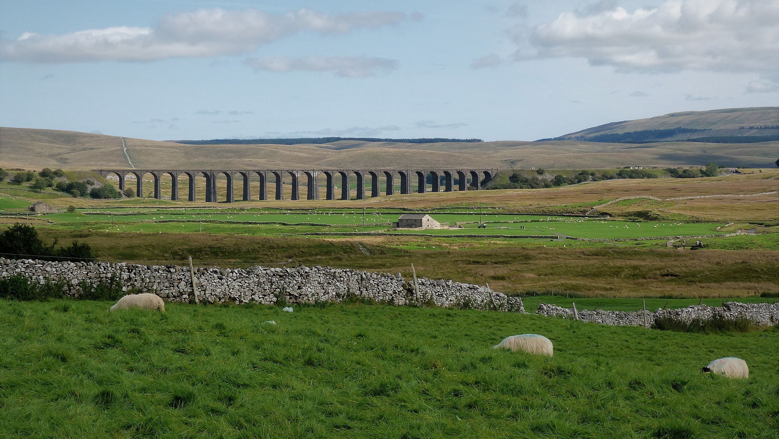 Ribblehead Viaduct in the Yorkshire Dales with sheep grazing nearby