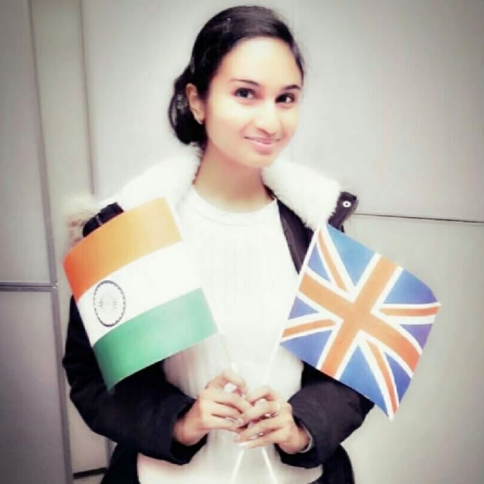Photo of Siddha Maloo holding a flag of India and a flag of Britain