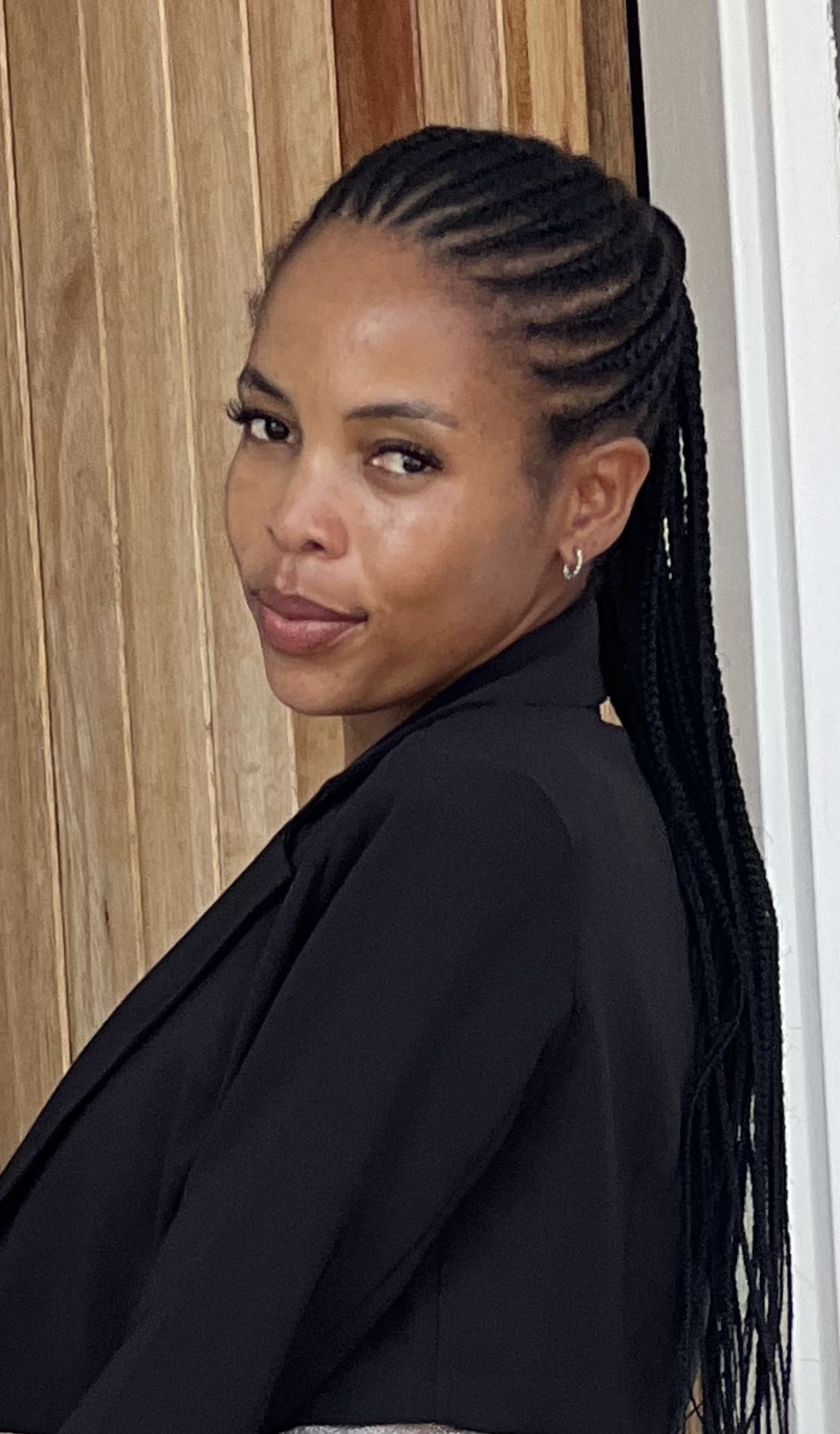 woman leaning against wall looking at camera