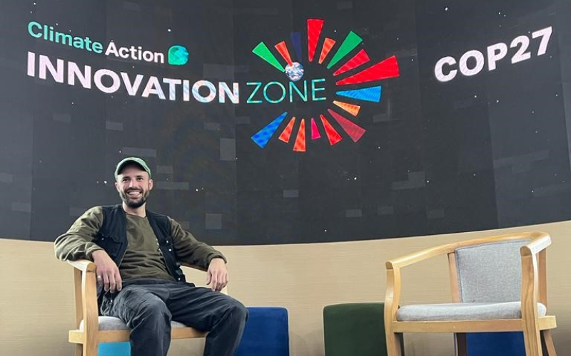 Theo sits on stage at COP27