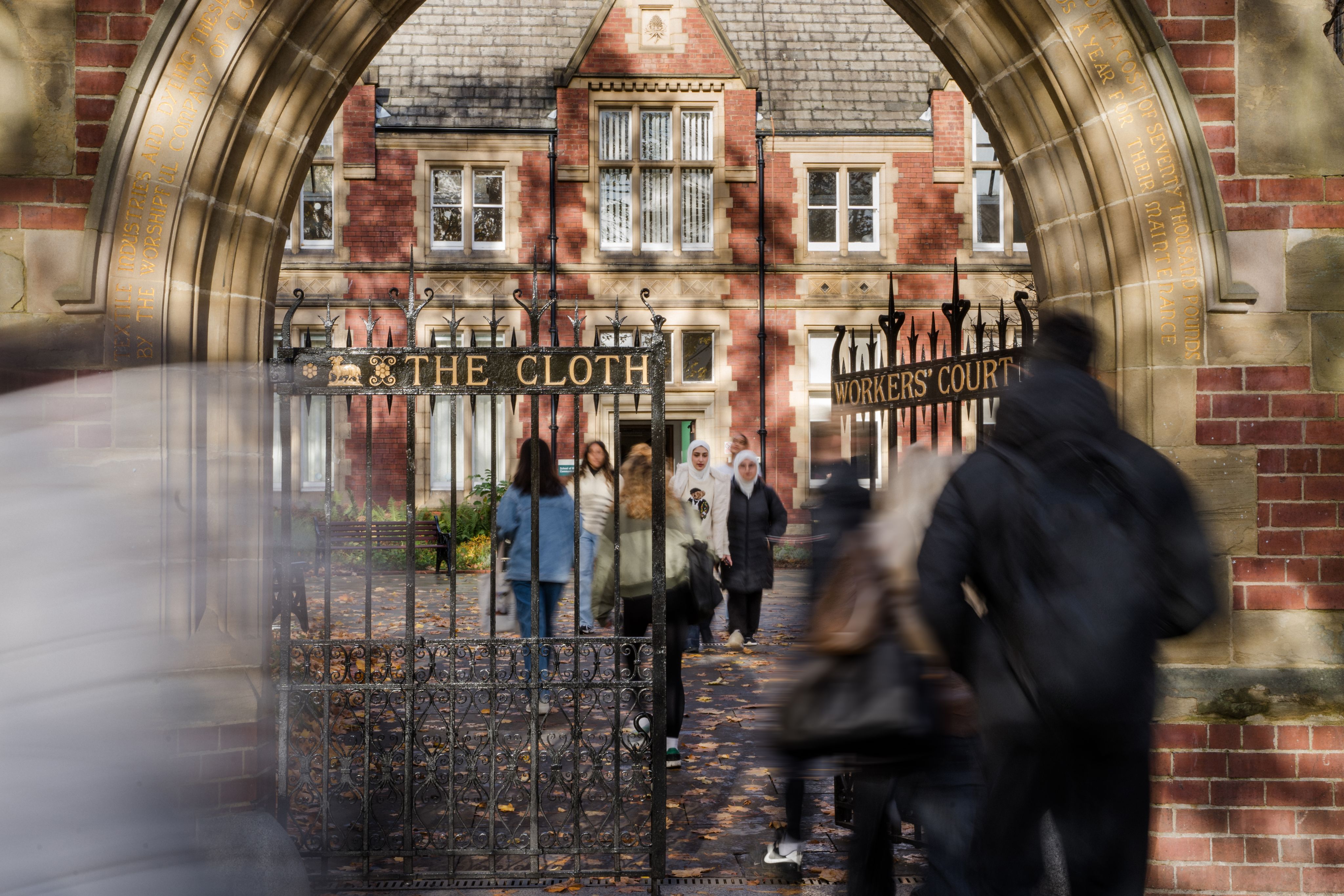 Students walk through the gates to Clothworkers Court