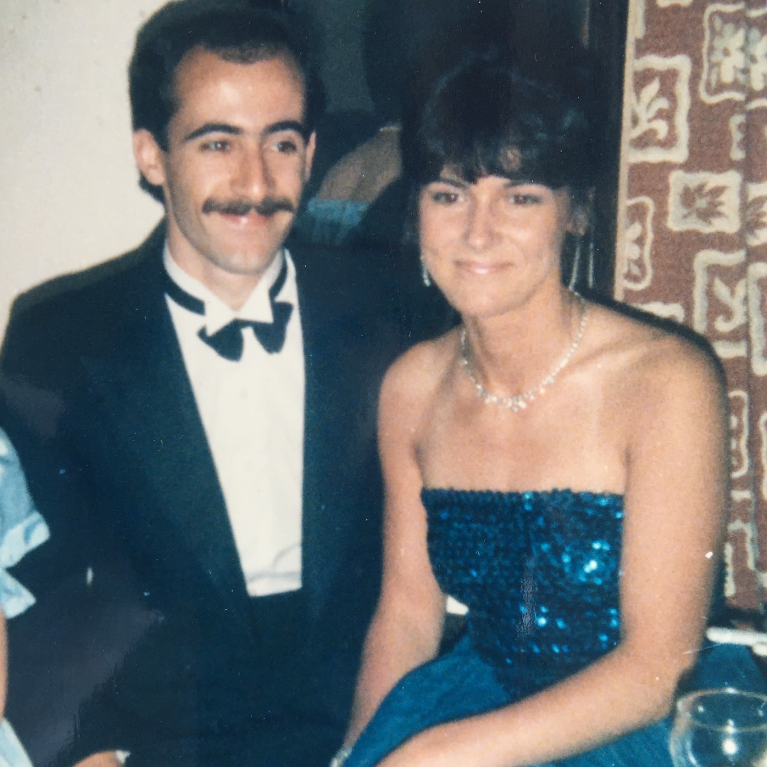 An old photo of a man and woman smartly dressed and smiling together