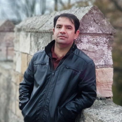 Photo of Muhammad Shehzad leaning against a wall