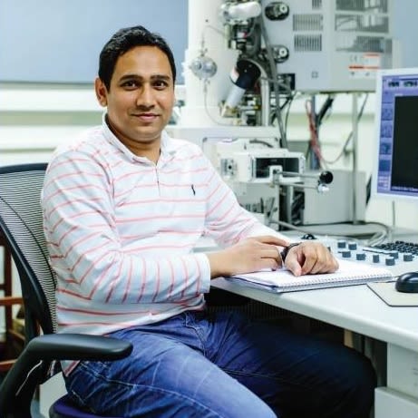 Photo of Nafis Ul Haque sat at a desk in a lab
