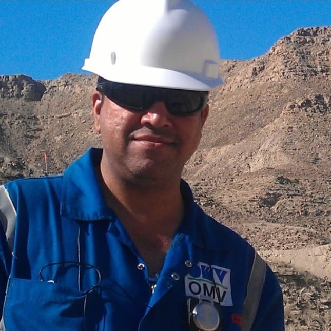 Photo of Fatehdin Junejo in overalls and a white hard hat