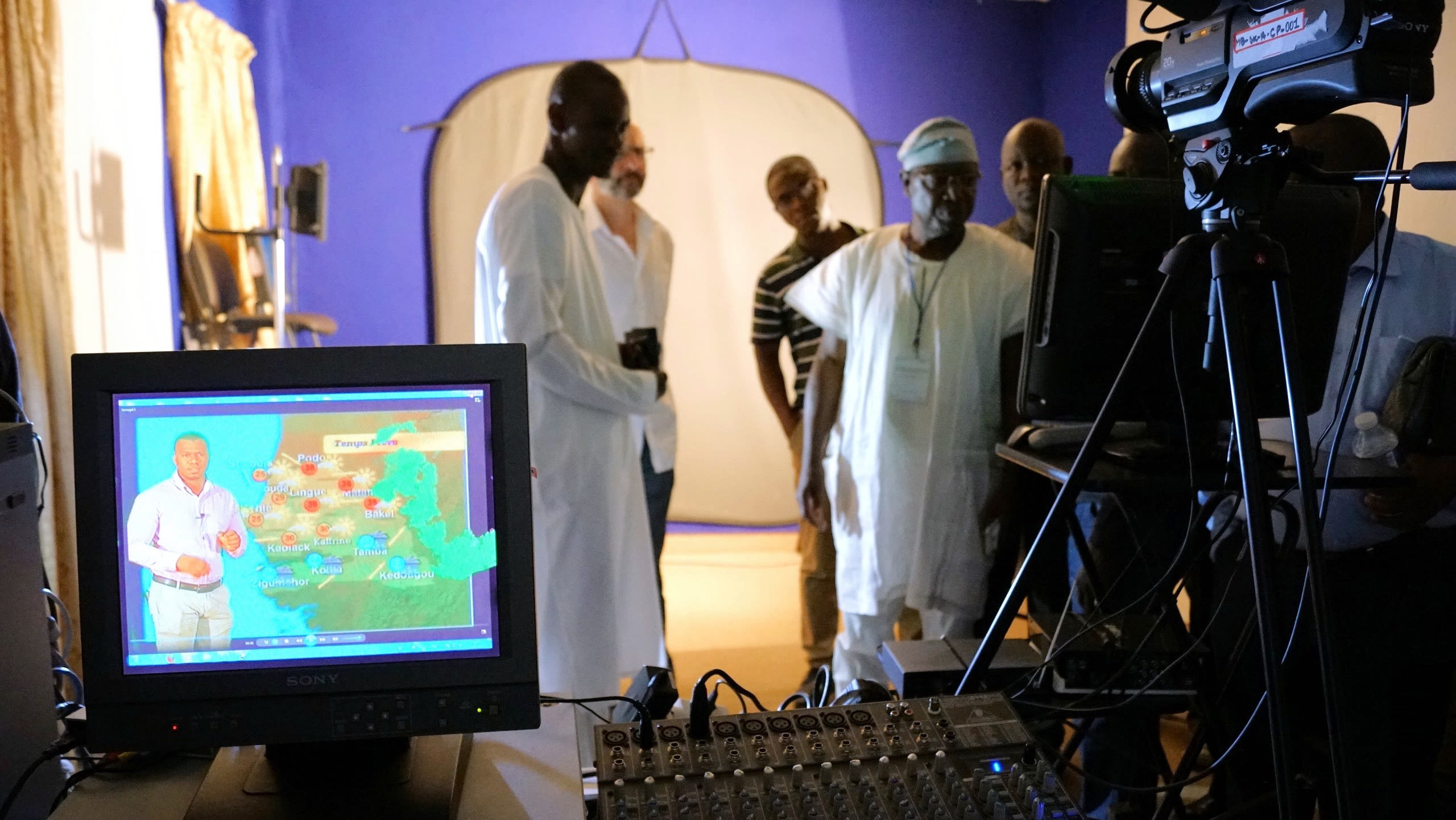 Scientists in a studio ready to give a weather briefing