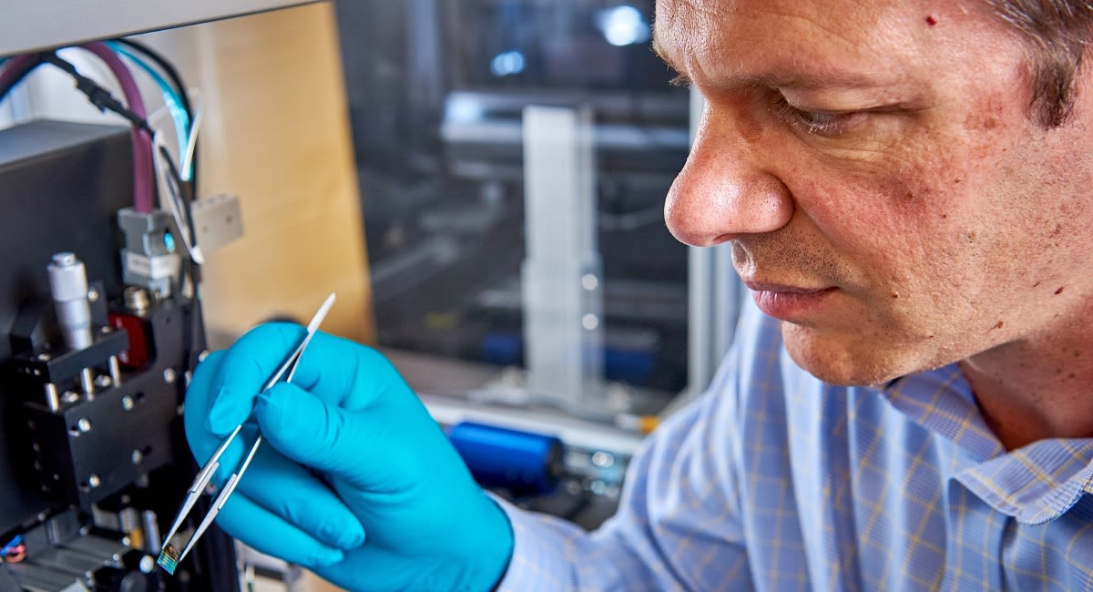 Professor Christoph Wälti inspects a microchip.