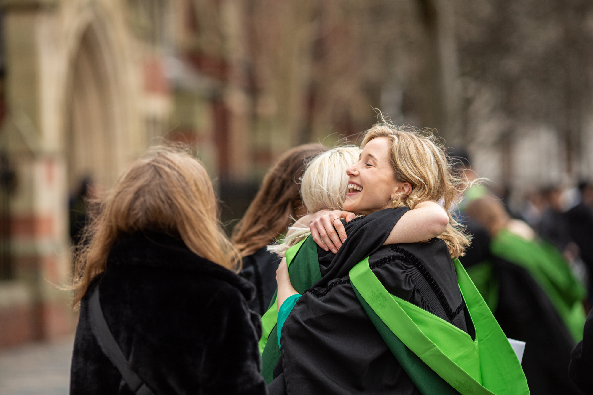 Graduates hug one another