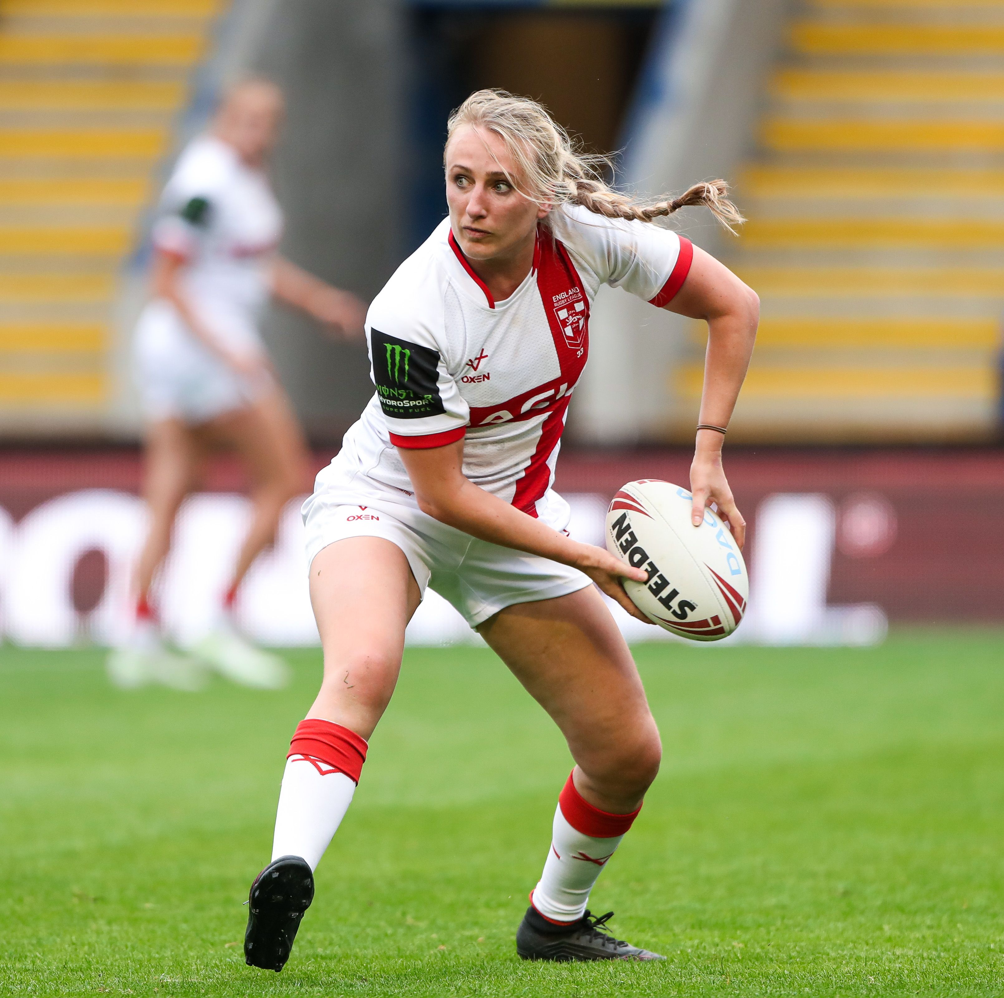 Jodie passes the rugby ball during a game