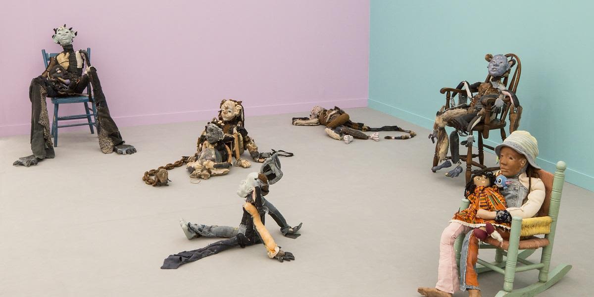 Sculpture by Tai Lewis featuring small human figures.